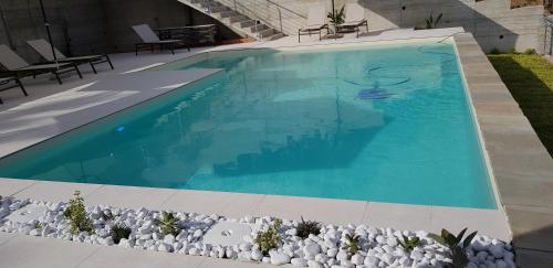 a swimming pool with blue water in a yard at Stella Marina Agropoli in Agropoli
