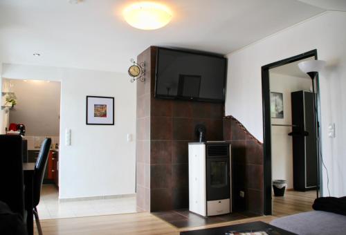 a living room with a tv on a wall at Haus am Donausee (House at the Danube Lake Beach) in Weitenegg