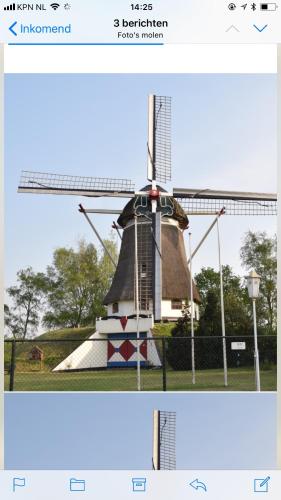 two pictures of a windmill in a field at De Heijense Molen Retro Camping in Heijen