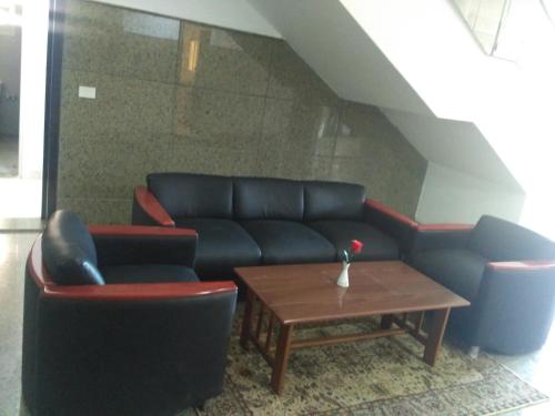 a living room with a couch and two chairs and a table at E-Just Hotel Borg El Arab in Borg El Arab