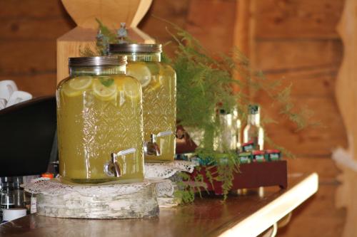 two mason jars filled with liquid sitting on a table at Pokoje i Domki Na Szlaku in Polanica-Zdrój