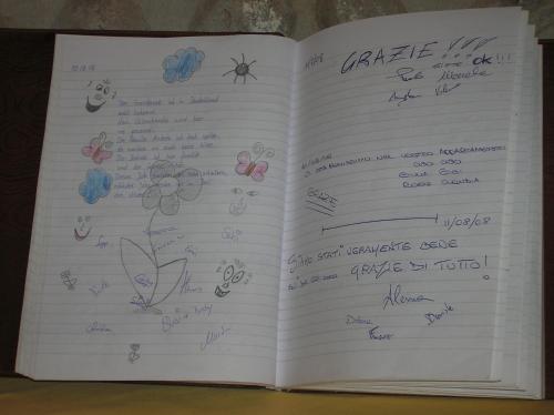 an open book with handwriting on the pages at Agriturismo Colombarola in Sona
