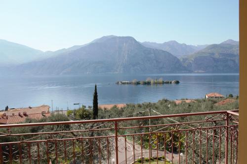 a view of a large body of water with mountains at Hotel Casa Gagliardi in Brenzone sul Garda