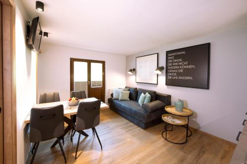 a living room with a couch and a table at Pension Baldauf - Dorf 31 in Kleinarl