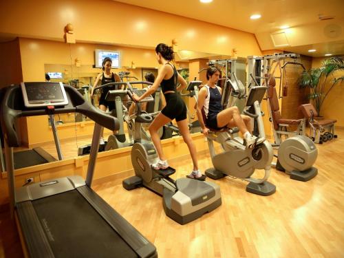 a group of people exercising on tread machines in a gym at Grand Hotel Baia Verde in Catania