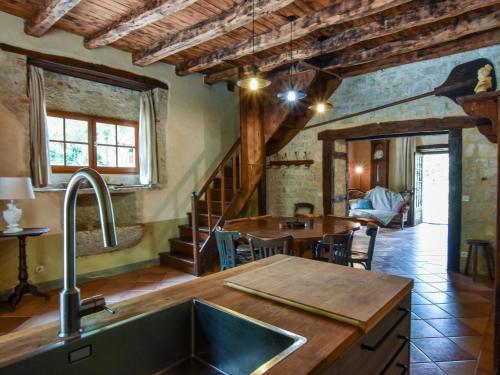 a kitchen with a sink and a dining room at Farmhouse in Saint-Cernin with Pool & Views in Saint-Cernin