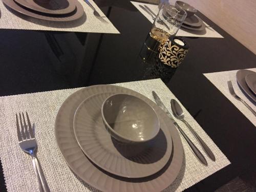 a table with a plate with a bowl on it at Crosswinds Nature View Suite in Tagaytay