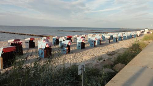 a row of colorful beach umbrellas on the beach at Parkhotel IV Jahreszeiten Kühlungsborn in Kühlungsborn