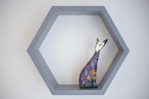 a colorful vase is sitting on a shelf at Apartman Šesna in Bol