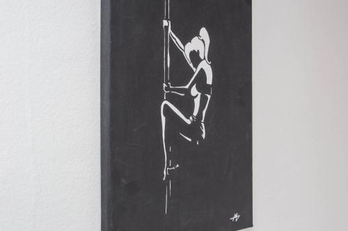 a drawing of a woman hanging on a wall at Apartman Šesna in Bol