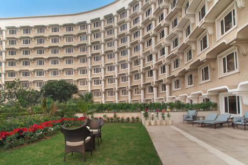 a large building with chairs and flowers in front of it at Taj Palace, New Delhi in New Delhi