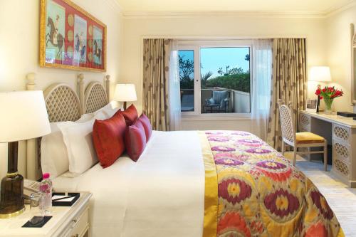 a hotel room with a bed and a balcony at Taj Palace, New Delhi in New Delhi