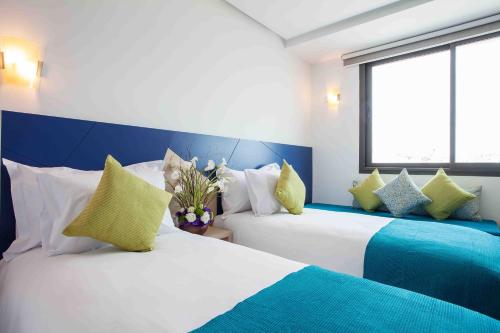 Un ou plusieurs lits dans un hébergement de l'établissement Relax Hotel Casa Voyageurs