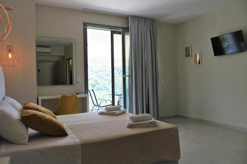 a bedroom with a bed with two towels on it at Kiperi Exclusive in Parga