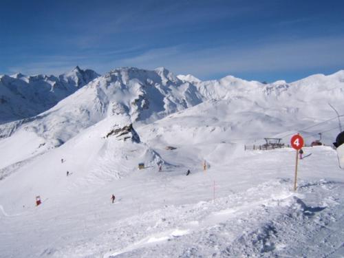 a snow covered mountain with people on a ski slope at Haus Benedikt in Heiligenblut
