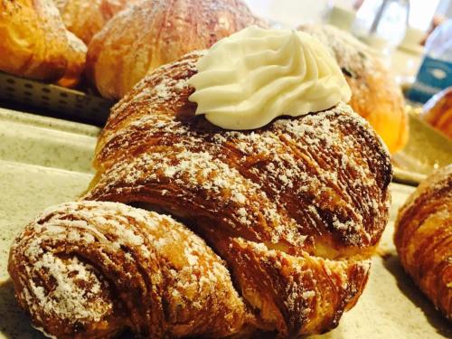 a bunch of pastries with whipped cream on top at Grand Hotel Victoria in Bagnara Calabra