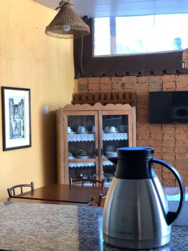 a tea kettle sitting on top of a table at Hotel Pousada Marista in Goiânia
