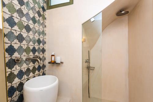 a bathroom with a toilet and a shower at Neratze Hammam Suites in Rethymno Town