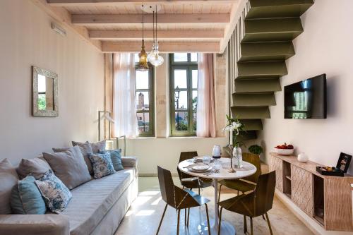 a living room with a couch and a table at Neratze Hammam Suites in Rethymno Town