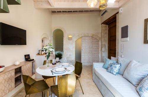 a living room with a couch and a table at Neratze Hammam Suites in Rethymno Town
