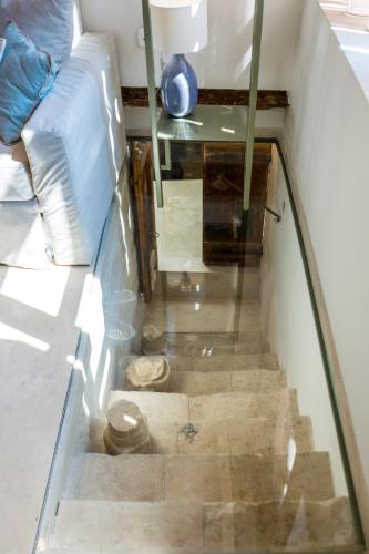 a staircase in a room with a couch and a table at Neratze Hammam Suites in Rethymno Town