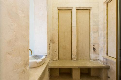 a bathroom with a toilet in the corner of a room at Neratze Hammam Suites in Rethymno Town