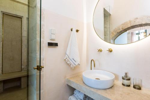 a bathroom with a sink and a mirror at Neratze Hammam Suites in Rethymno Town