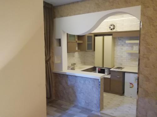 a kitchen with a sink and a counter top at Al Worod Al Thahabia Chalets in Abha