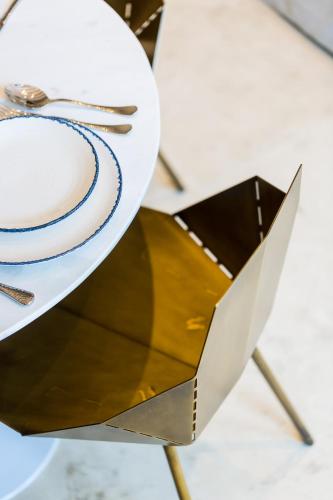 a table with a white plate and fork and knife at Neratze Hammam Suites in Rethymno Town