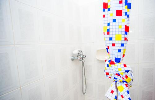 a bathroom with a shower with a colorful shower curtain at Haus Manya in Lassy in Lassi