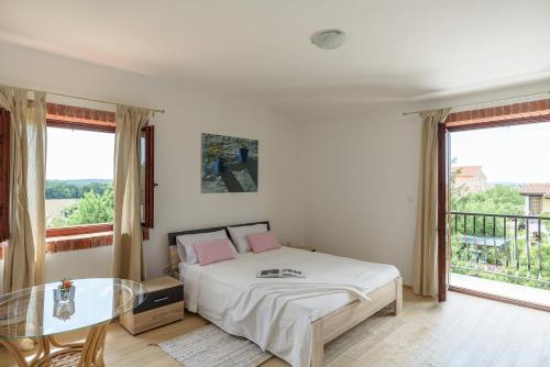 a bedroom with a bed and a glass table at Accomodation TERRAROSSA in Fažana