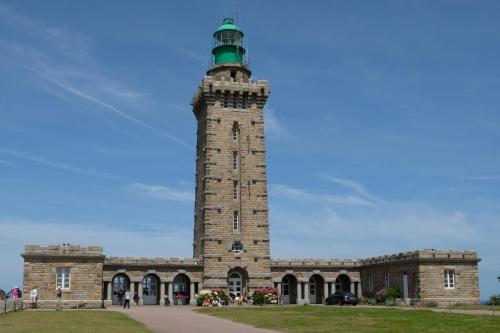 a building with a lighthouse on top of it at Hotel De Diane in Sables-dʼOr-les-Pins
