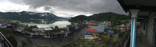 a view of a city with a river and mountains at Lake Vision Guesthouse in Pokhara