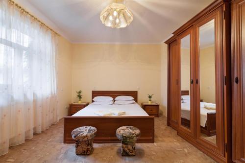 a bedroom with a bed and a large mirror at Paradise apartments in Lviv