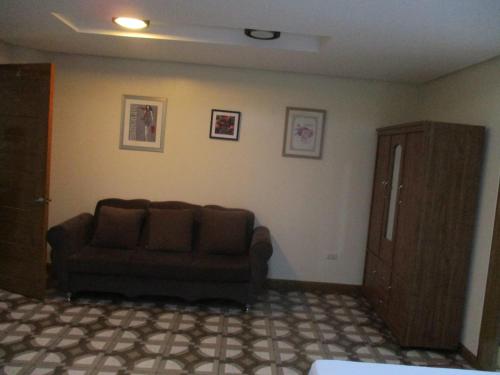 a living room with a couch and a cabinet at WMV Hotel & Restaurant in Infanta