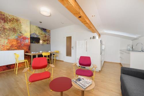 ein Wohnzimmer mit bunten Stühlen und einem Tisch in der Unterkunft Appartementhaus Winter in Radstadt