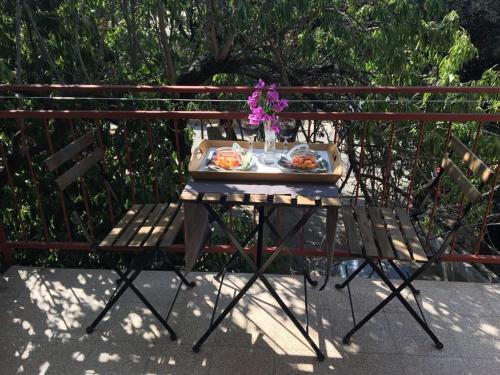 a table with a plate of food and flowers on it at Bed & Breakfast Kurtic in Supetar