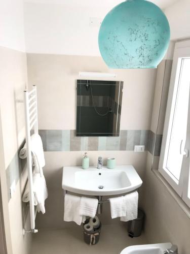 a bathroom with a sink and a mirror at B&B Red Village in Chieti