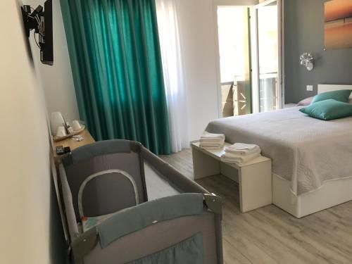 a bedroom with a bed and a green curtain at Casa Mara in Chioggia