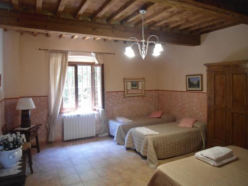 Ένα ή περισσότερα κρεβάτια σε δωμάτιο στο Agriturismo Le Pescine