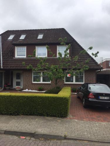 a house with a car parked in front of it at Haus Steffens in Esens