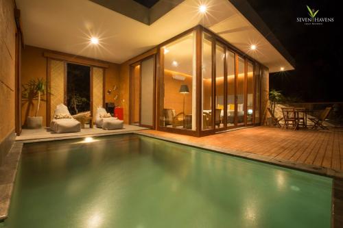 a swimming pool in the middle of a house at Seven Havens Residence in Selong Belanak