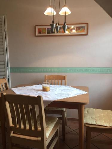 a dining room table with a white table and chairs at Haus Steffens in Esens