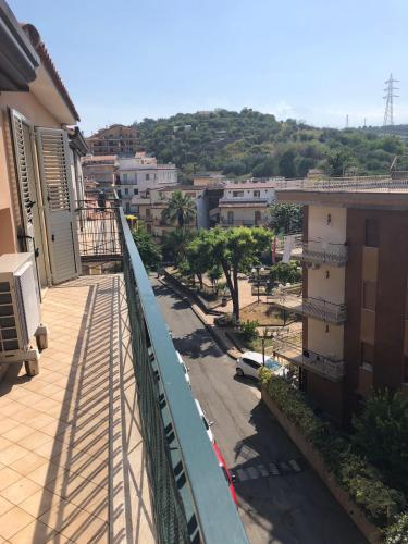 a balcony of a building with a view of a city at Atticus Apartment in Giardini Naxos