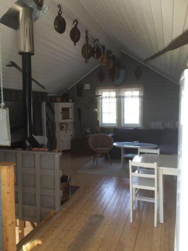 a kitchen and living room with a table and a stove at Lofot Loftet in Svolvær