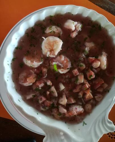 a bowl of shrimp soup on a white plate at Hosteria Cumilinche in Same