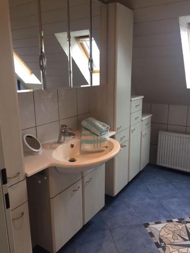 a bathroom with a sink and a mirror at Haus Steffens in Esens