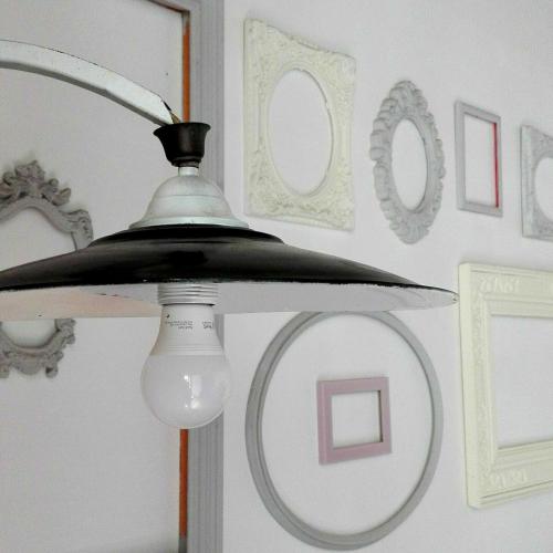 a ceiling light in a room with pictures on the wall at Il Rosciolo Sulla Francigena in Formello