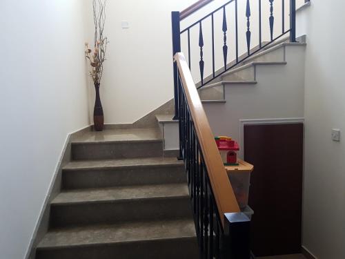 a staircase with a stair railing and a vase at Nayia Paradise Villa! Best Villa in Cyprus in Paphos City