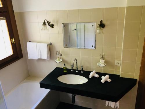 a bathroom with a sink and a mirror at Stilvolle 3-Zimmer Wohnung in Jugendstilvilla in Flims